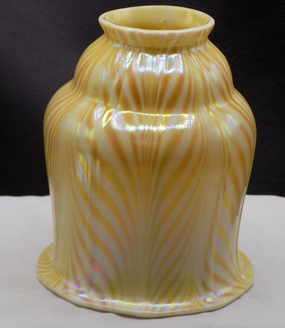 Pulled feather art glass lamp shade: Pulled feather art glass lamp shade. In manner of Quezel or Steuben. No markings. Fitter rim 2 ¼ x 5 ¼ tall. Bottom rim 4 3/8 inches. Beautiful colors. In very good original as found conditi