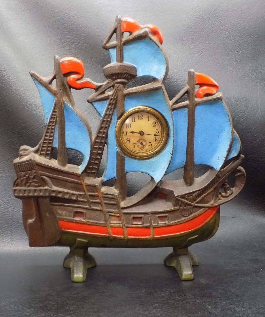 Antique cast iron ship with clock: Antique cast iron ship with clock. Marked on back as shown in photo. Clock is not running at time of listing. Beautiful colors. In very good original as found condition. Great quality and detail. 11 5