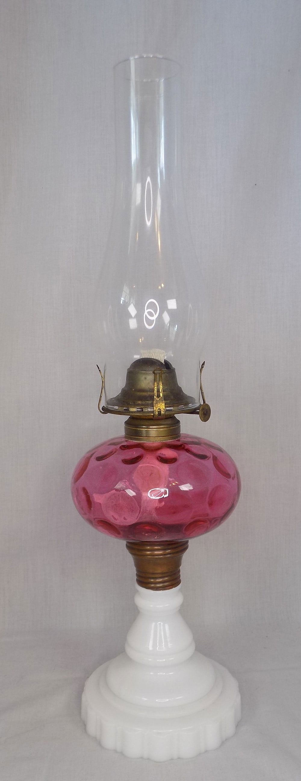 Victorian antique cranberry coin dot oil lamp: Victorian antique cranberry coin dot oil lamp. Milk glass base. Beautiful colors. Queen Anne on font wick adjuster. In very good original as found condition. 21 inches tall to top of chimney. Lamp bas