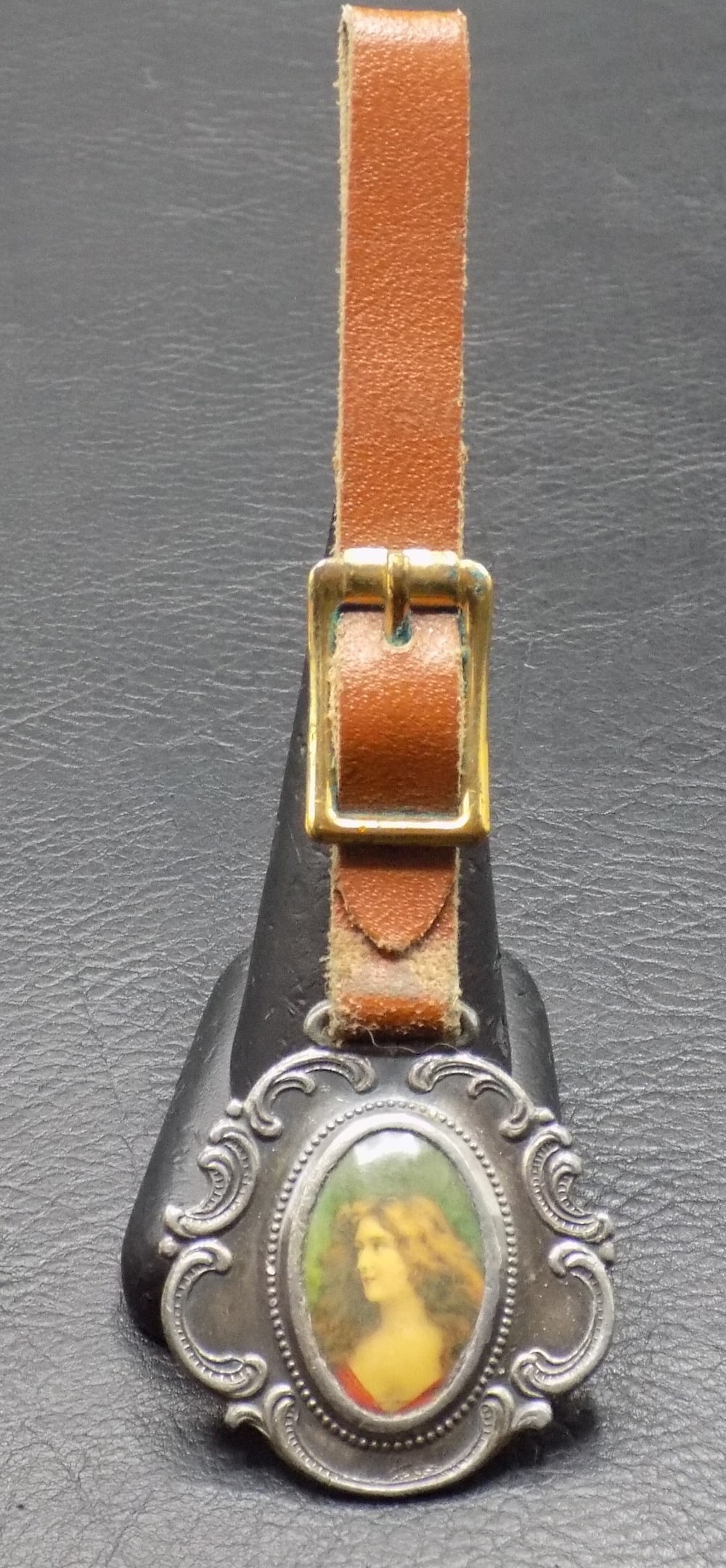 Antique portrait advertising watch fob. Atlanta GA: Antique portrait advertising watch fob. Atlanta GA. The Aragon and the Majestic Hotels. Female portrait. Leather strap. Please see photos for condition. Great quality and detail. Total length 5 inches