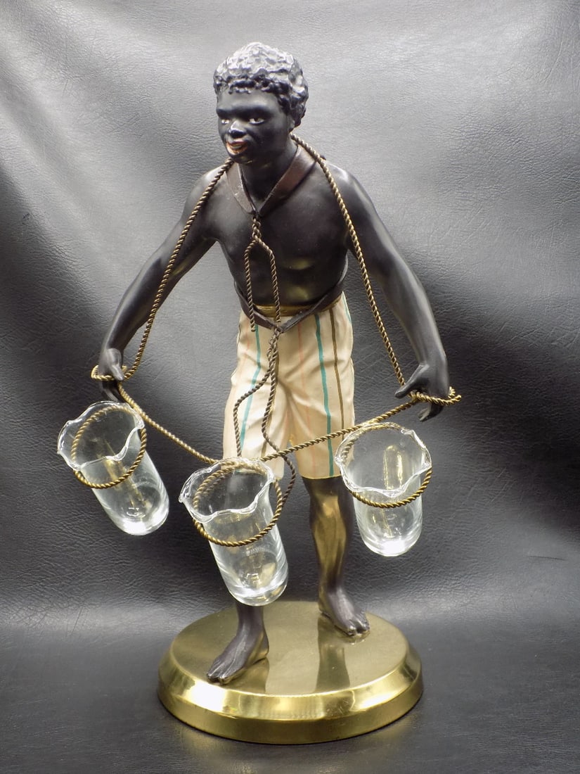 Vintage hand painted Blackamor figure with vases: Vintage hand painted Blackamor figure with vases. Metal figure with original cold paint. Label Petites Choses USA on bottom as shown in photo. Three glass vases. Beautiful colors. In very good origina