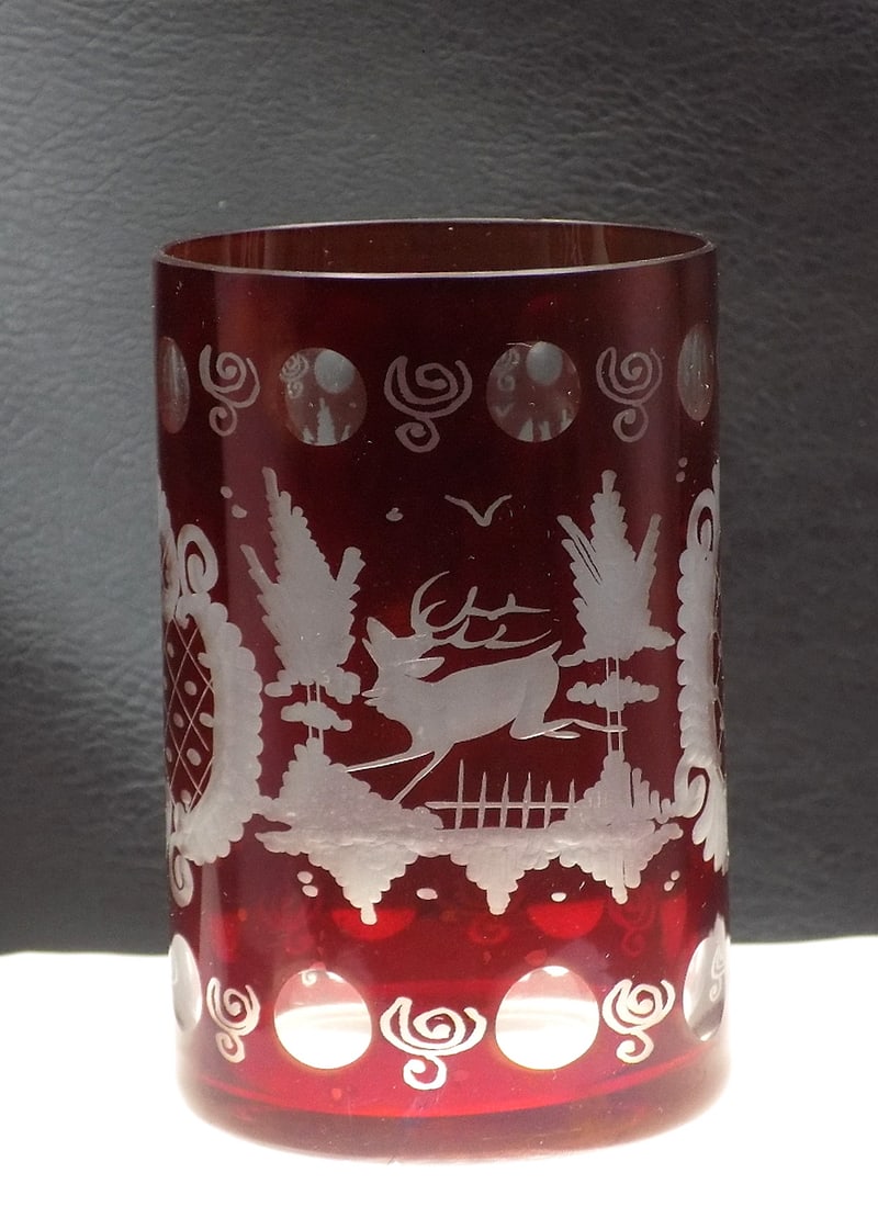 Vintage red cut to clear art glass drinking glass: Vintage red cut to clear art glass drinking glass. With deer and buildings. Beautiful colors. In very good original as found condition. Great quality and detail. White lines or dots are camera flash r
