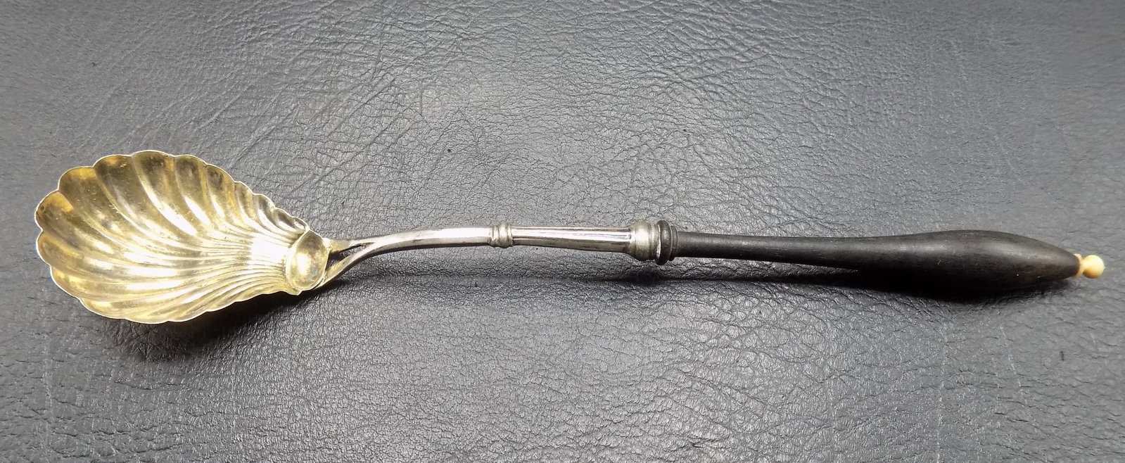 Antique ornate sterling sugar spoon with shell shaped bowl and ebonized wood handle (1 of 3)