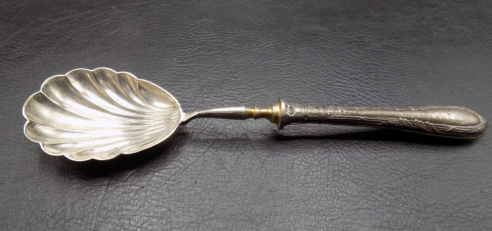 Antique 875 silver ornate cream or sauce spoon with shell shaped bowl: Antique 875 silver ornate cream or sauce spoon with shell shaped bowl. 36 grams. Marked on handle. In very good original as found condition. Great quality and detail. 7 3/8 inches long. For in house s