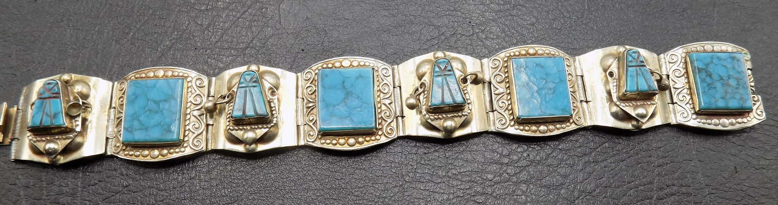 Beautiful vintage turquoise and sterling silver bracelet: Beautiful vintage turquoise and sterling silver bracelet. Marked as shown in photo. Beautiful colors. In very good original as found condition. Great quality and detail. 7 ¾ inches long opened. 2