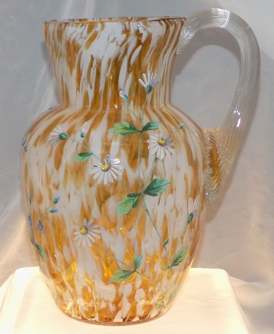 Victorian floral decorated art glass pitcher: Victorian floral decorated art glass pitcher. Hand painted enamel flowers. Clear applied handle. In very good original as found condition. Great quality and detail. White spots are camera flash reflec