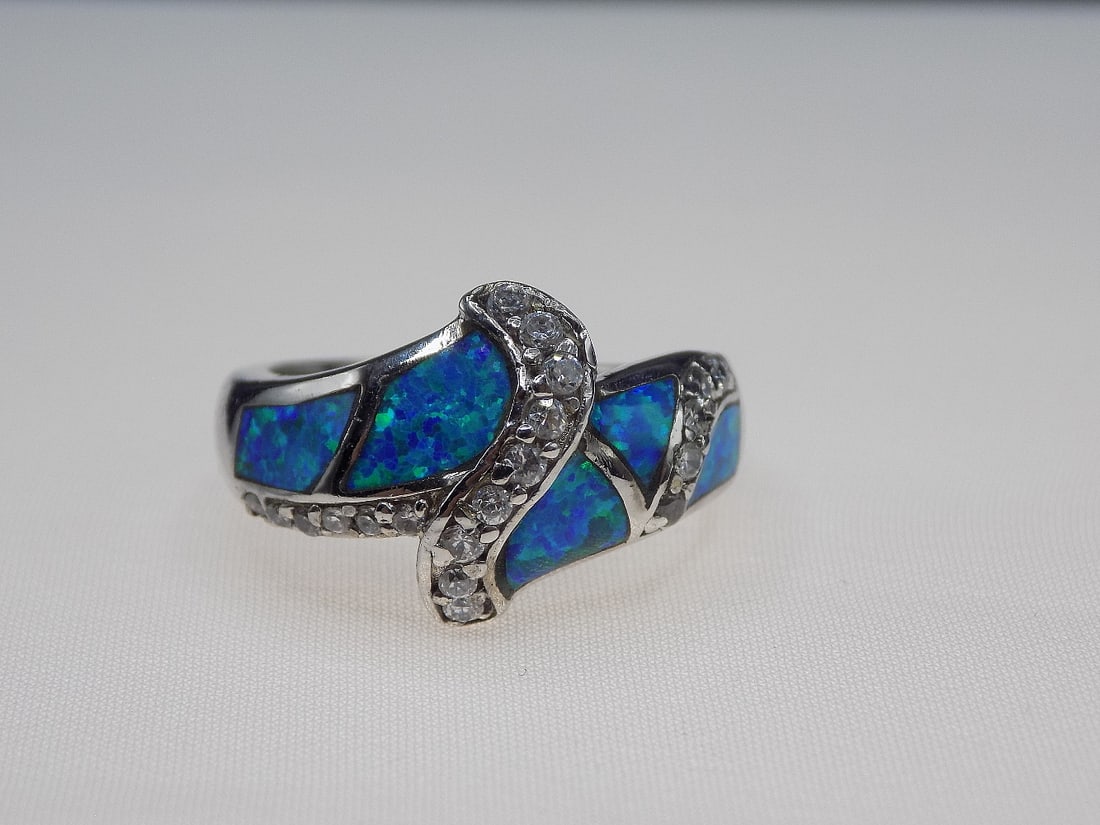 Beautiful 2 cwt and Australian opal and topaz sterling silver ring: Beautiful 2 cwt and Australian opal and topaz sterling silver ring. Lab created. Size 7. For in house shipping, please call Mike at Thriftiques 319-321-0613. Click the preferred shipping method for in