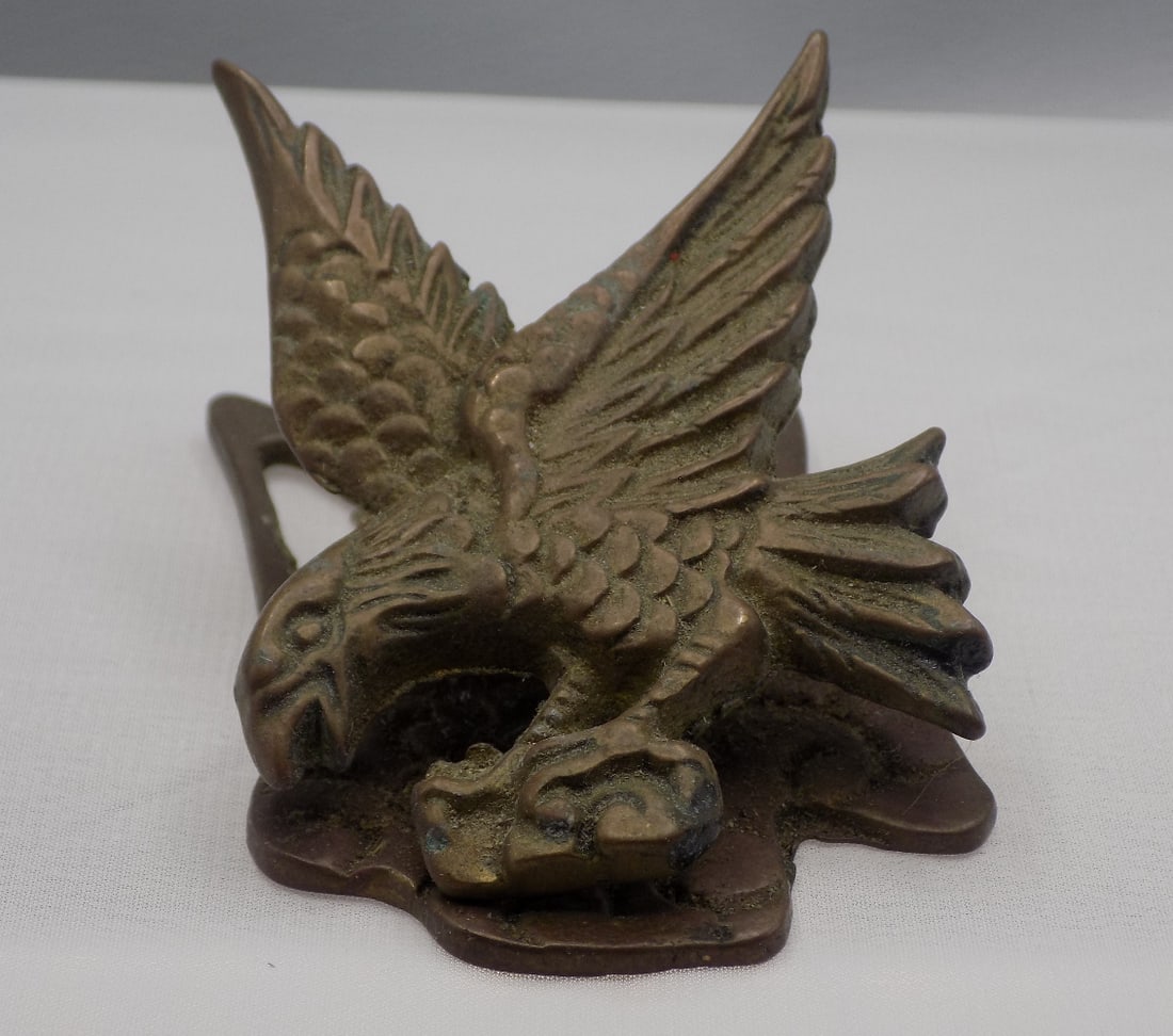 Neat antique brass eagle desk clip: Neat antique brass eagle desk clip. Original patina. In very good original as found condition. Great quality and detail. 3 ¼ tall x 2 inches wide. 5 ounces. For in house shipping, please call Mik