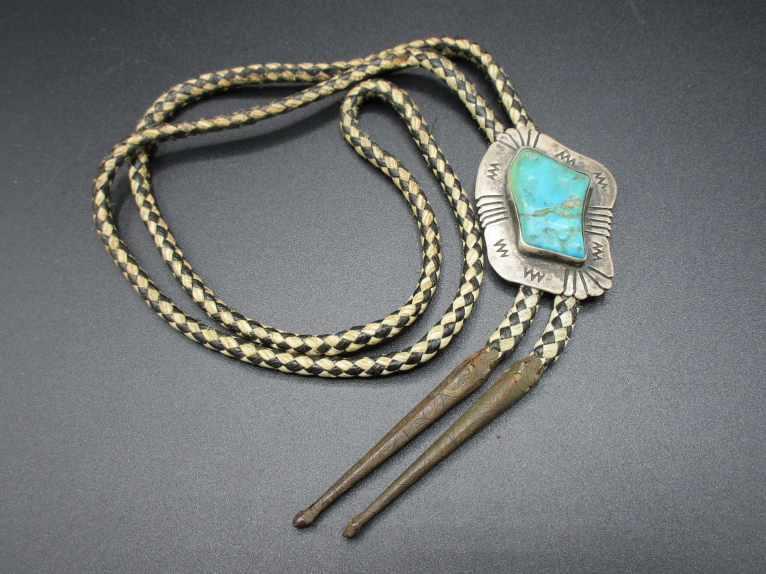 Vintage Native American Indian turquoise and sterling bolo tie: Vintage Native American Indian turquoise and sterling bolo tie. Measures 16 ½ in long. And turquoise is 1 3/8 inches tall. 22 grams.. In very good original as found condition. Great quality and