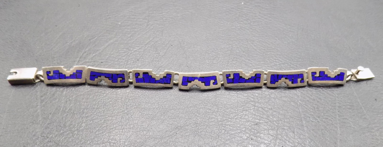 Vintage lapis lazuli inlaid sterling silver bracelet: Vintage lapis lazuli inlaid sterling silver bracelet. Marked as shown in photo. Beautiful colors. In very good original as found condition. Great quality and detail. 7 ½ long opened. 1 ounce. For