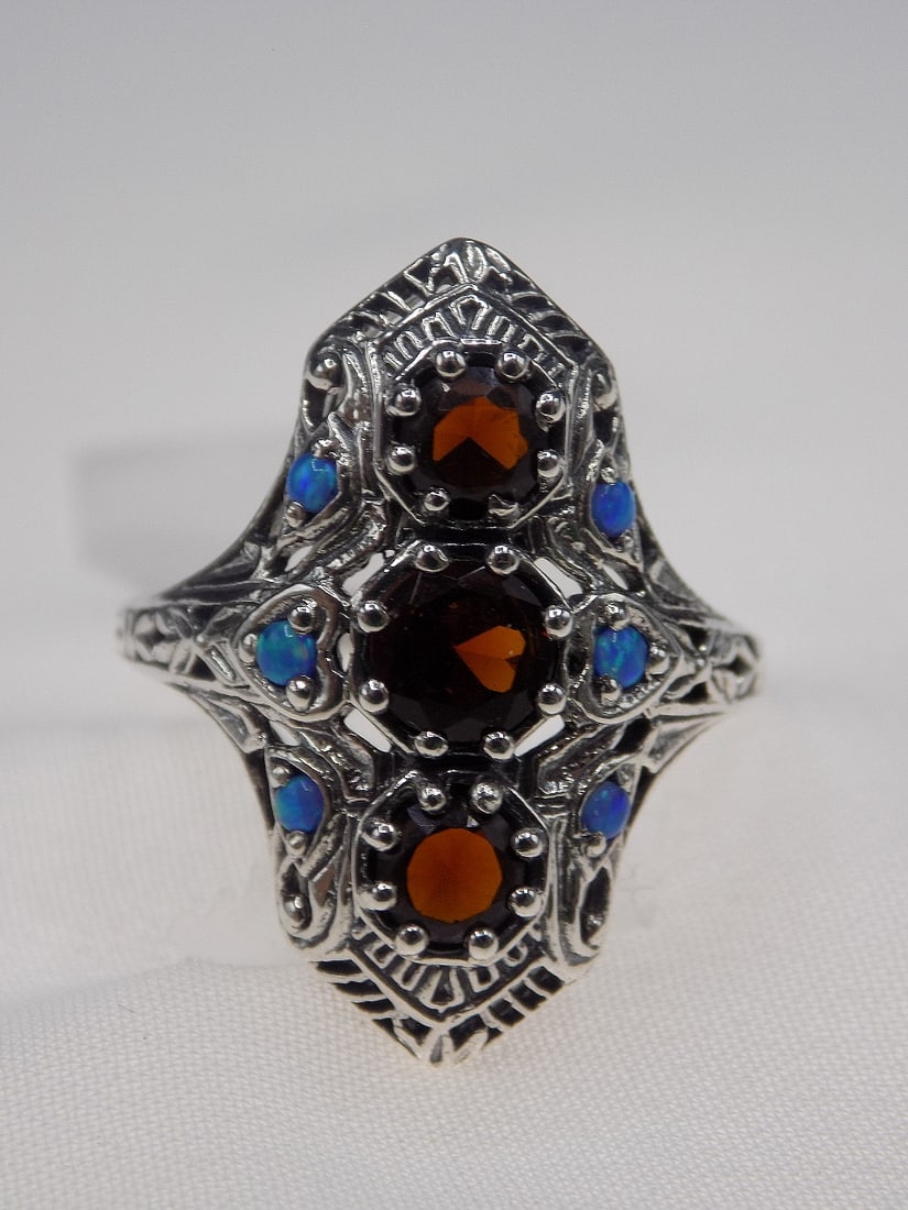 Beautiful 3 cwt fire garnet and blue fire opal sterling silver ring.: Beautiful 3 cwt fire garnet and blue fire opal sterling silver ring. Lab created. Size 7 . For in house shipping, please call Mike at Thriftiques 319-321-0613. Click the preferred shipping method for 