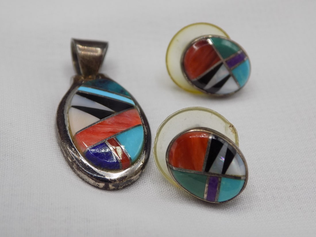 Native American Indian pendant and earrings. Artist signed: Native American Indian pendant and earrings. Artist signed. Marked as shown in photo. Inlaid turquoise, coral, mother of pearl and jet. Beautiful colors. In very good original as found condition. Grea