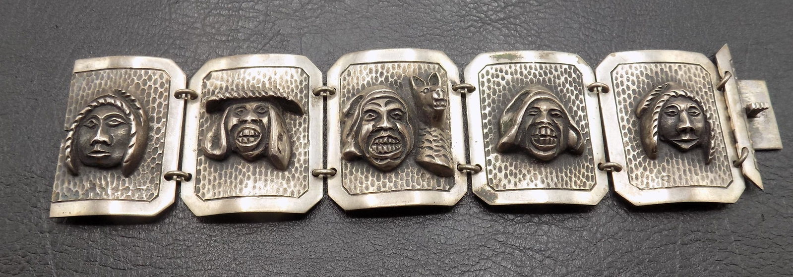 Unusual 800 silver panel with high relief carved faces and masks bracelet (1 of 3)