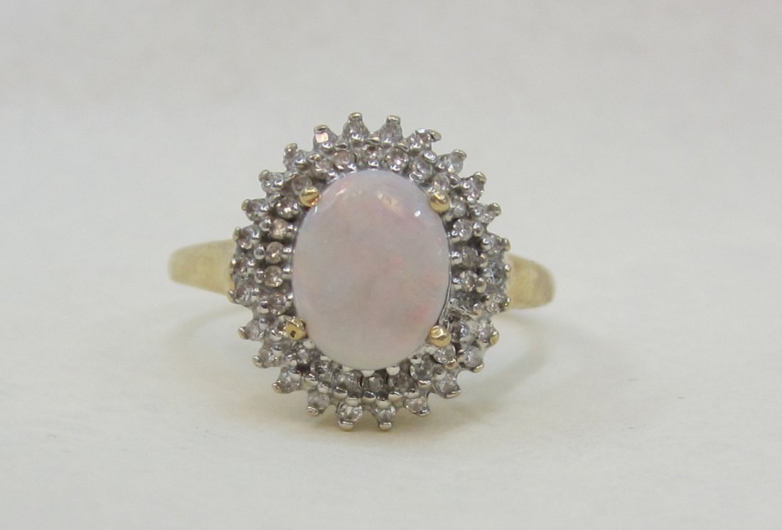 Beautiful 10 K - , 2 CT. Fire Opal and diamond ring: Beautiful 10 K - , 2 CT. Fire Opal and diamond ring Size 8. Weighs 3.8 Grams.