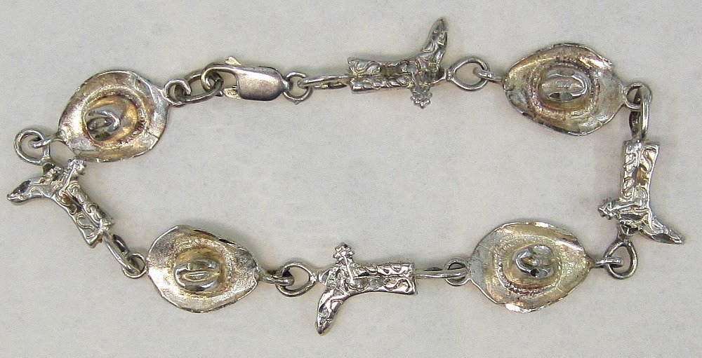 Sterling Silver Ladies Cowboy and Boot Charm Bracelet.: Sterling Silver Ladies Cowboy and Boot Charm Bracelet. There are 4 hat charms and 4 boot charms. The clasp is marked .925. All Hats are marked .925. I could not find a mark on the boots; however they