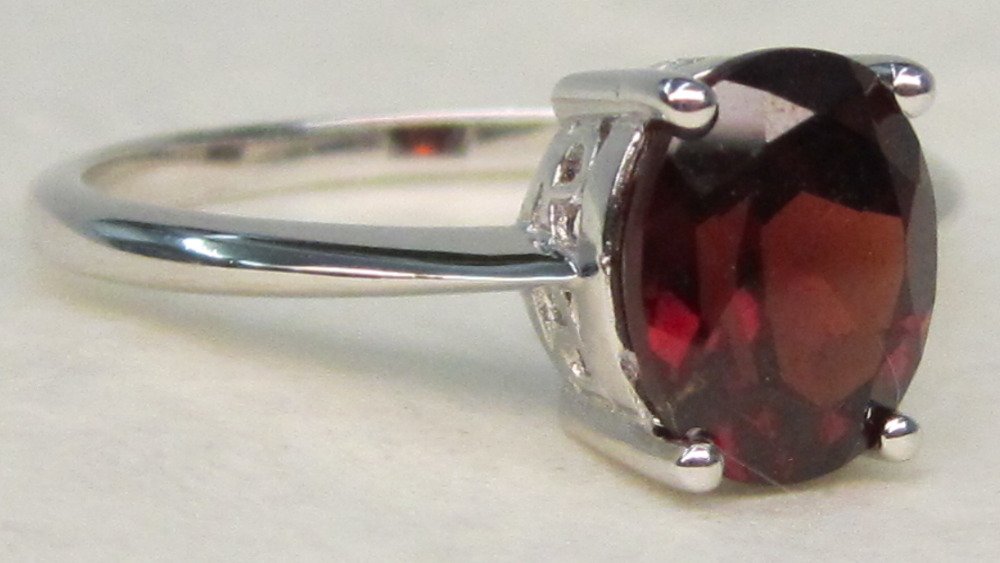 Genuine Garnet Solitaire .925 Sterling Filigree Ring: Gorgeous Genuine Red Garnet Solitaire .925 Sterling Silver with Filigree Setting Ring. The picture does not do justice to how beautiful this Garnet is truly is. The Oval Garnet measures approximately 
