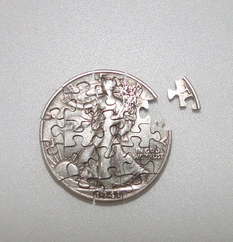 Walking Half Dollar Puzzle.: Very unique conversation piece! A walking half dollar that has been meticulously cut into a working jigsaw puzzle!