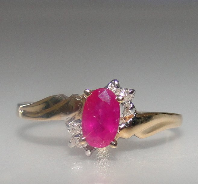 10K Ruby and Diamond Ring: 10K gold ring with 6x4mm ruby center and diamond accents.