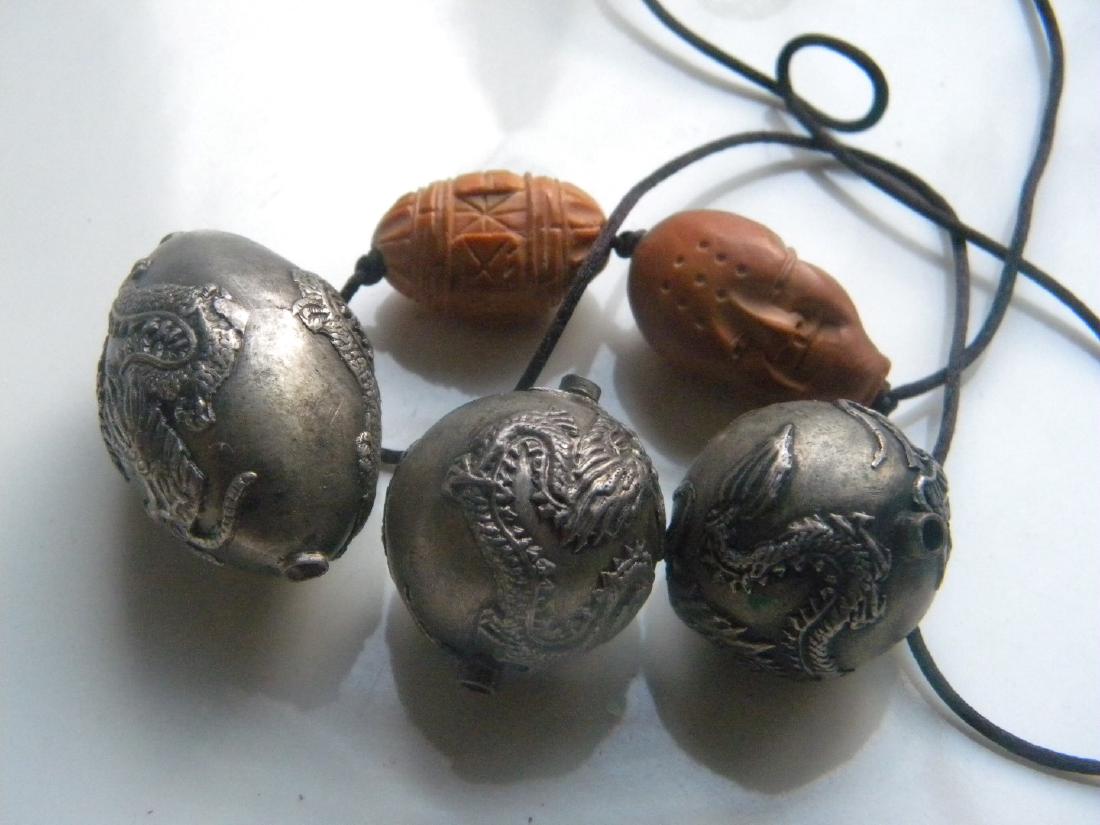 Two Chinese Carved Nut Pit and Three Dragon Balls: Two Chinese Carved Nut Pit and Three Dragon Balls, size of nut pit: 1"