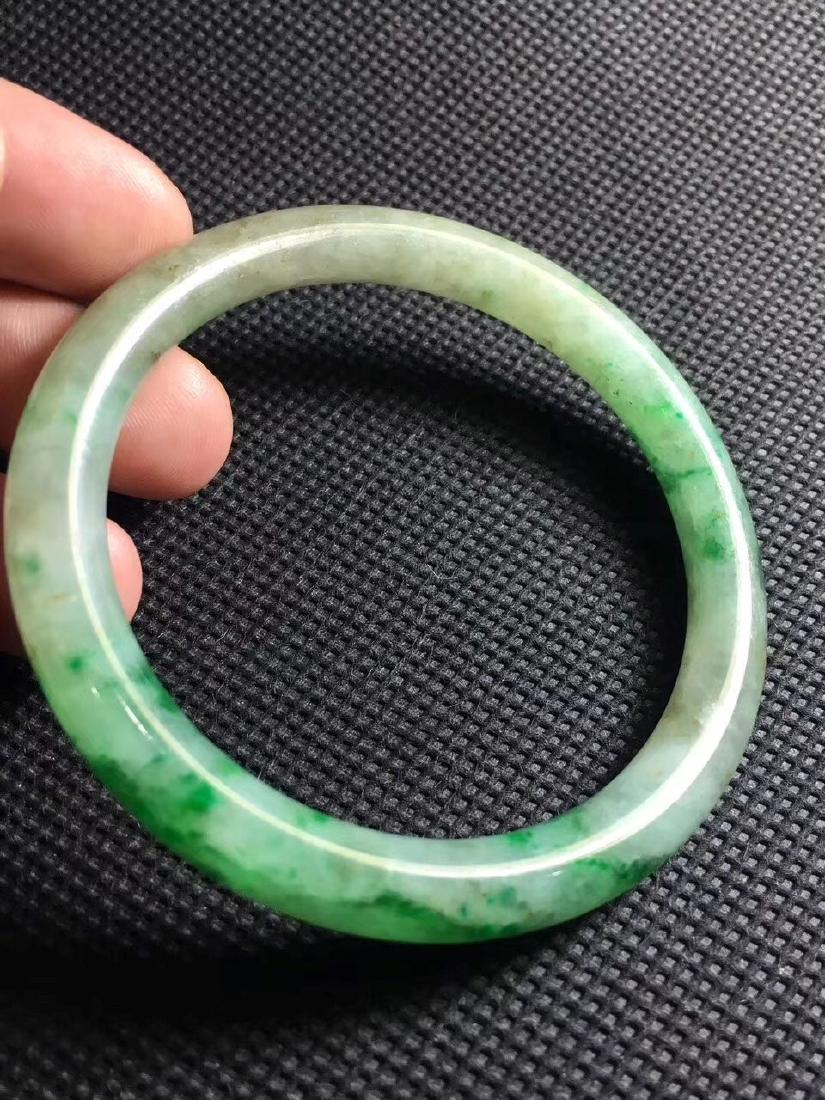 A JADEITE BANGLE, QING DYNASTY (1 of 4)