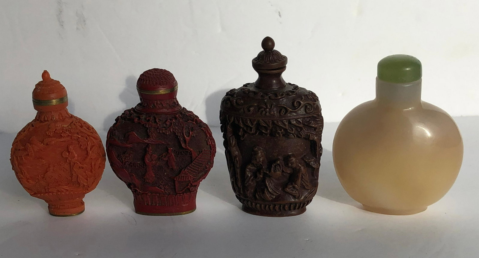 Four Carnelian and Lacquer Snuff Bottles: Four Carnelian and Lacquer Snuff Bottles