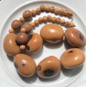 Tannish roundish colored design necklace