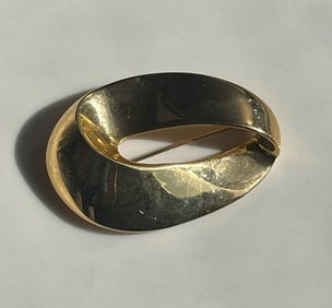 Elegant gold Color brooch with a unique design.