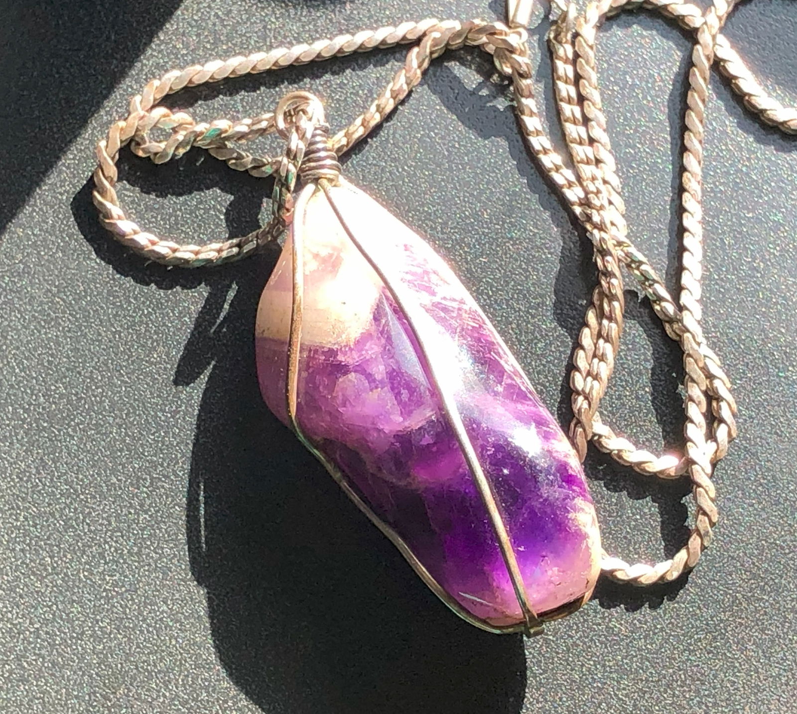 Amethyst Pendant Silver Necklace: A beautiful amethyst pendant wrapped in Silver wire, perfect for any occasion. Marked Sterling.