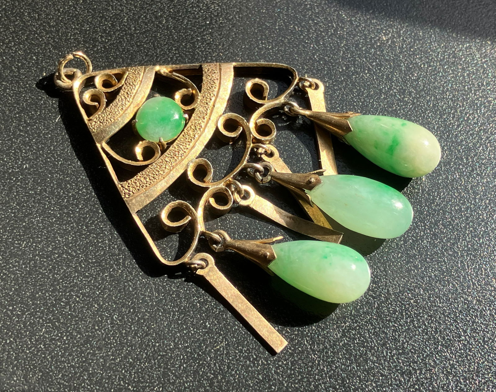 Elegant Jadeite Pendant: A beautifully crafted pendant featuring jadeite stones and intricate metalwork.