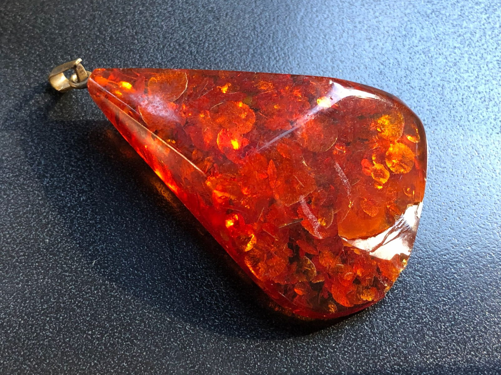 Amber Pendant: A beautiful Amber pendant with a smooth finish. Size: 2.5".