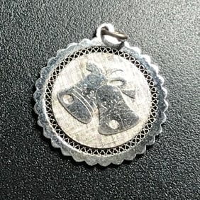 round silver pendant. 2 bells decorate front
