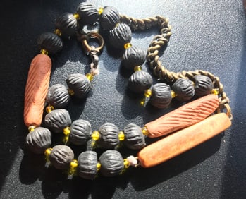 necklace, long ornage and round black bead design