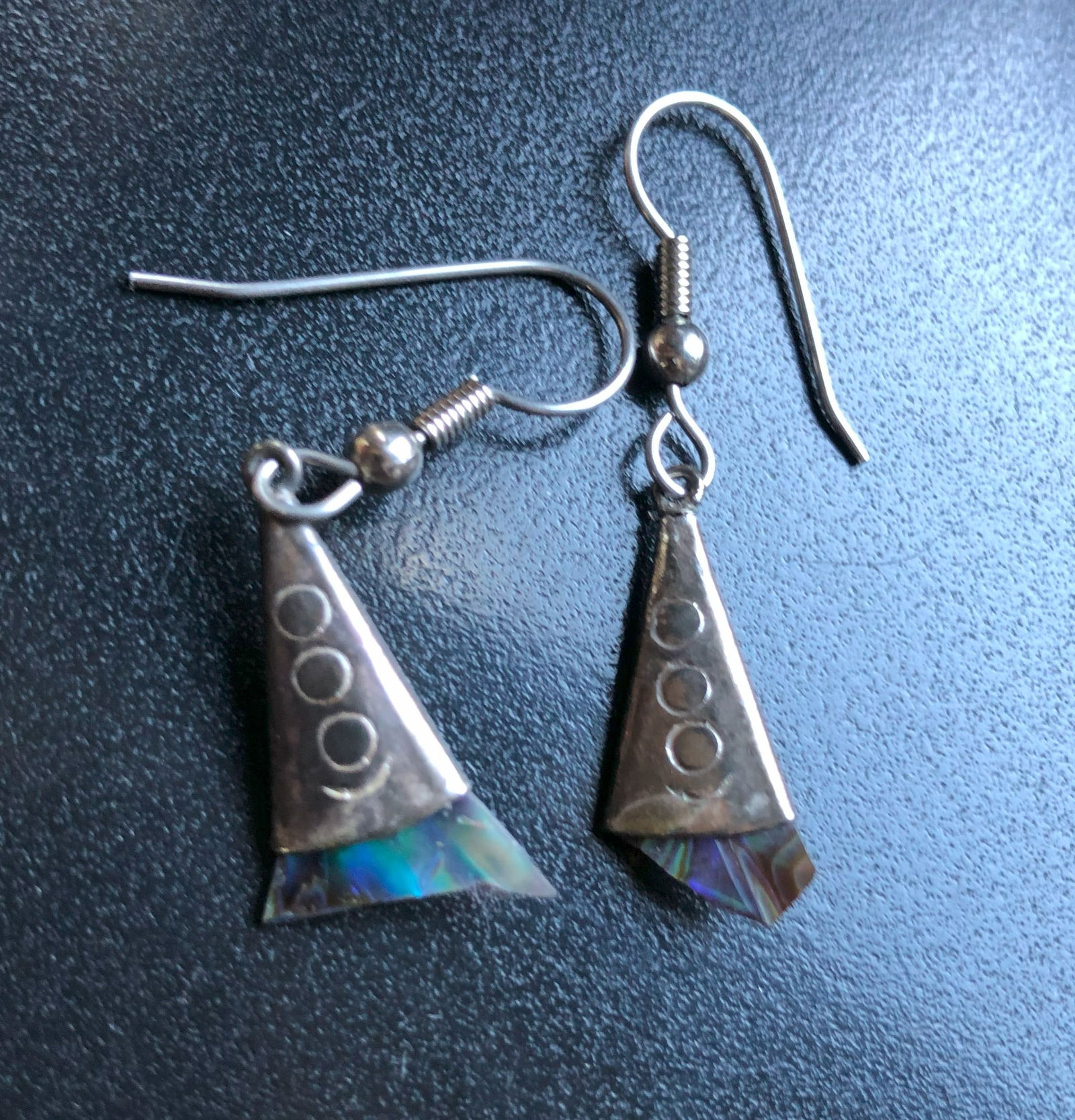 Silver Triangle Earrings: Elegant silver earrings with a triangular design and abalone shell accents.