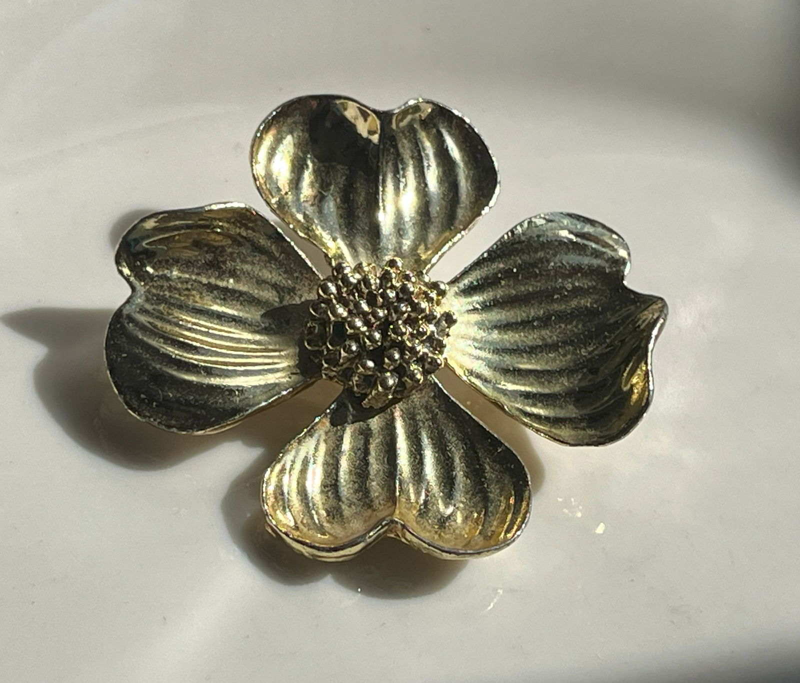 A beautiful gold Color flower brooch with intricate detailing. (1 of 3)