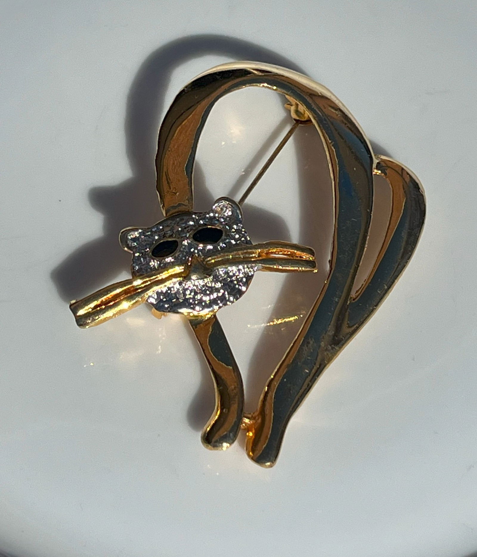 Cat Brooch: Elegant cat-shaped brooch with gold and silver tones.