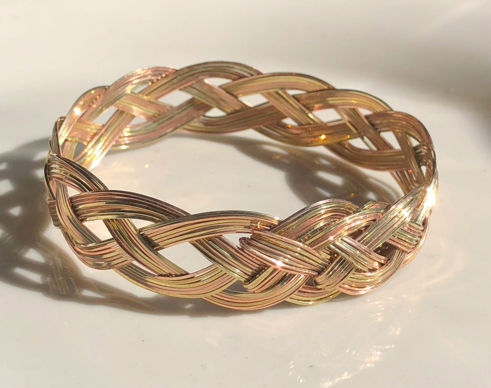 Braided Gold Color Bracelet: A beautifully crafted braided gold color bracelet, perfect for any occasion.