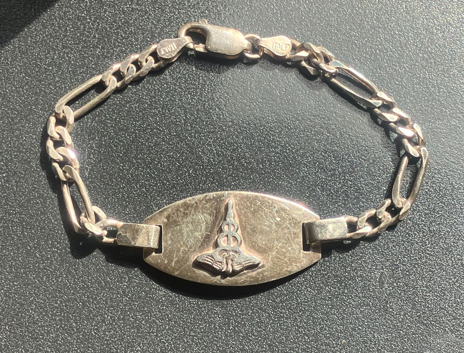 Silver Bracelet: A stylish silver bracelet with a unique design.