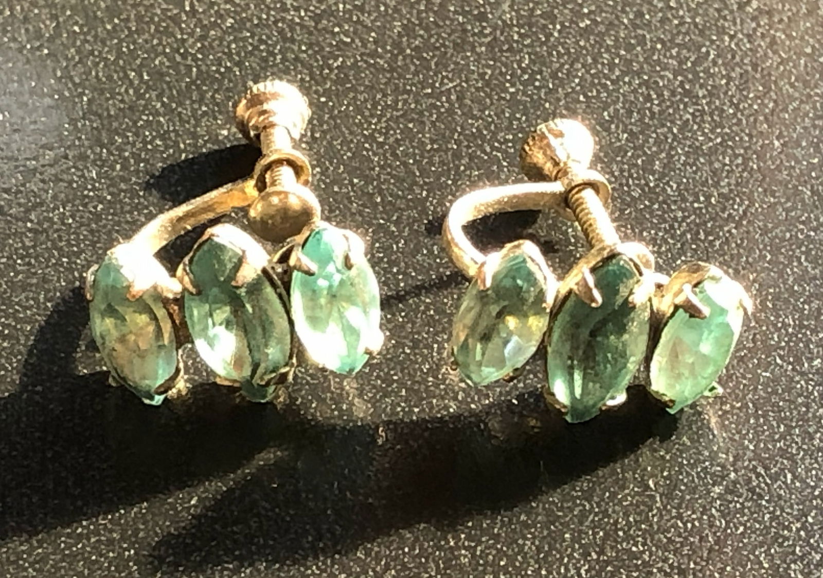 Vintage Screw-back Earrings: Elegant vintage screw-back earrings with green gemstones.