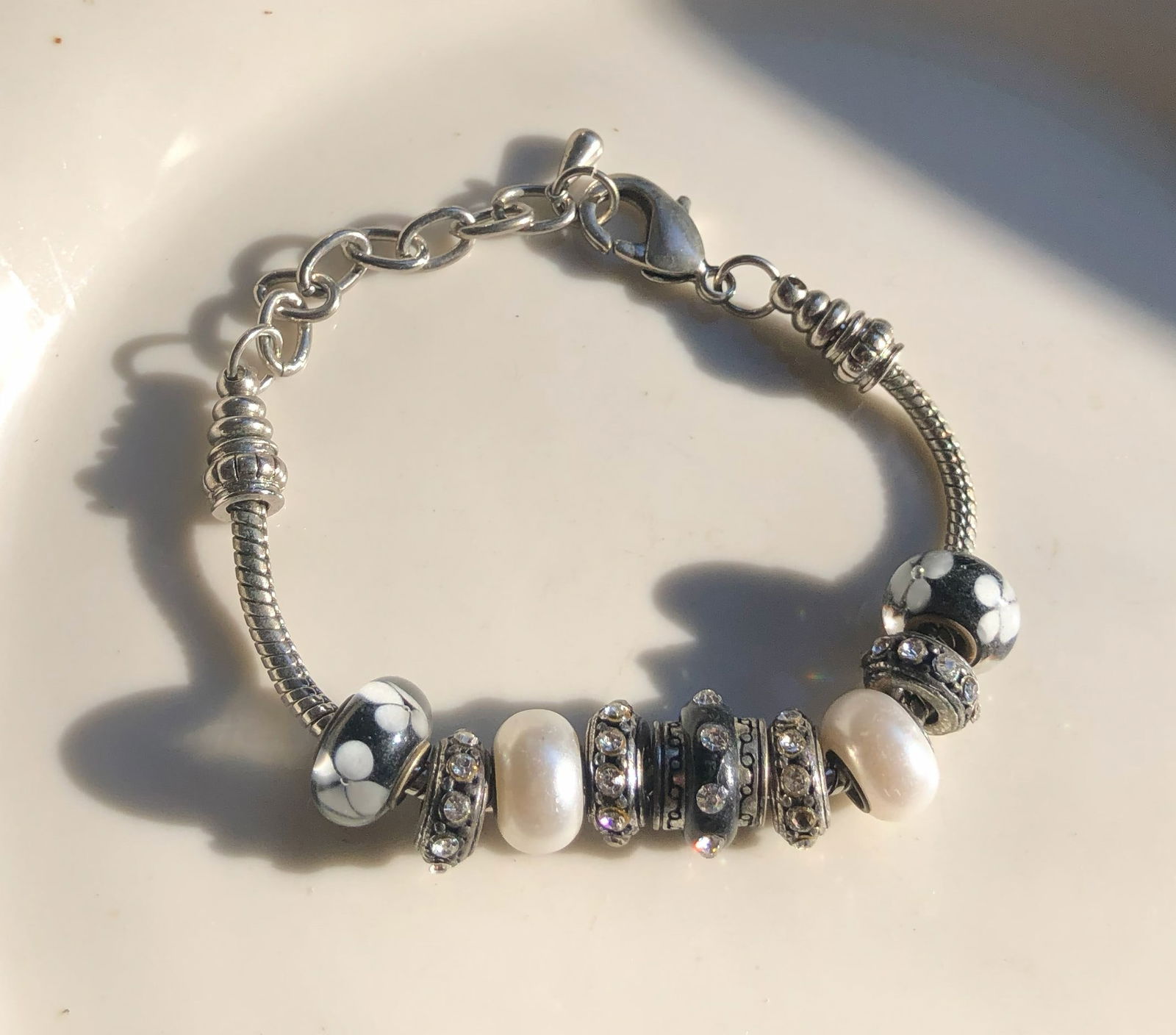 Elegant Charm Bracelet: A beautiful charm bracelet featuring elegant beads and pearls.