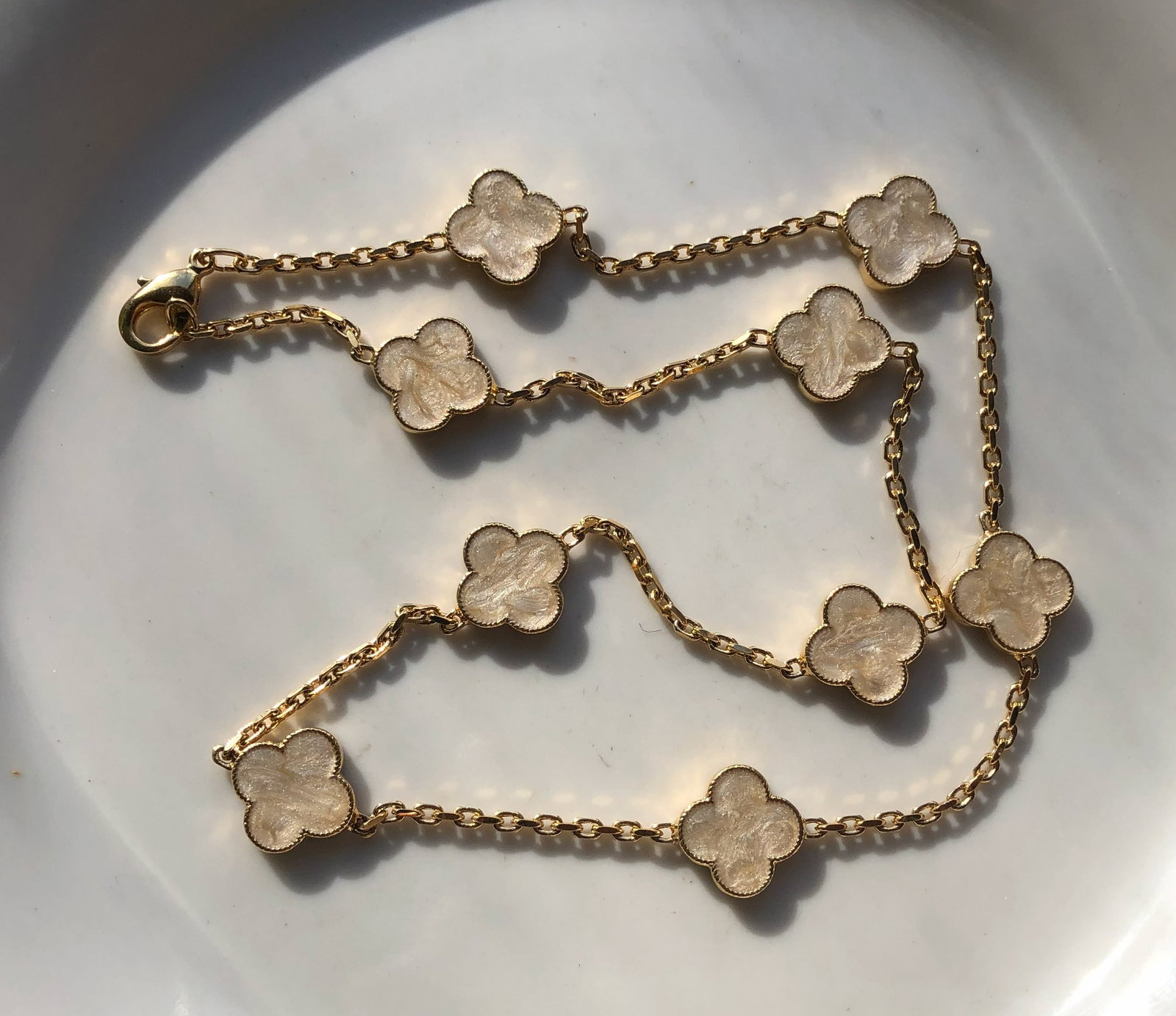 Gold Color Clover Necklace: Elegant gold Color necklace with clover-shaped charms.
