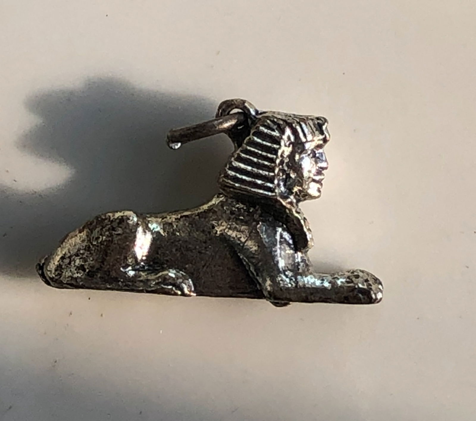 Sphinx Silver Pendant: A detailed Sphinx pendant made of silver. Size: 1".