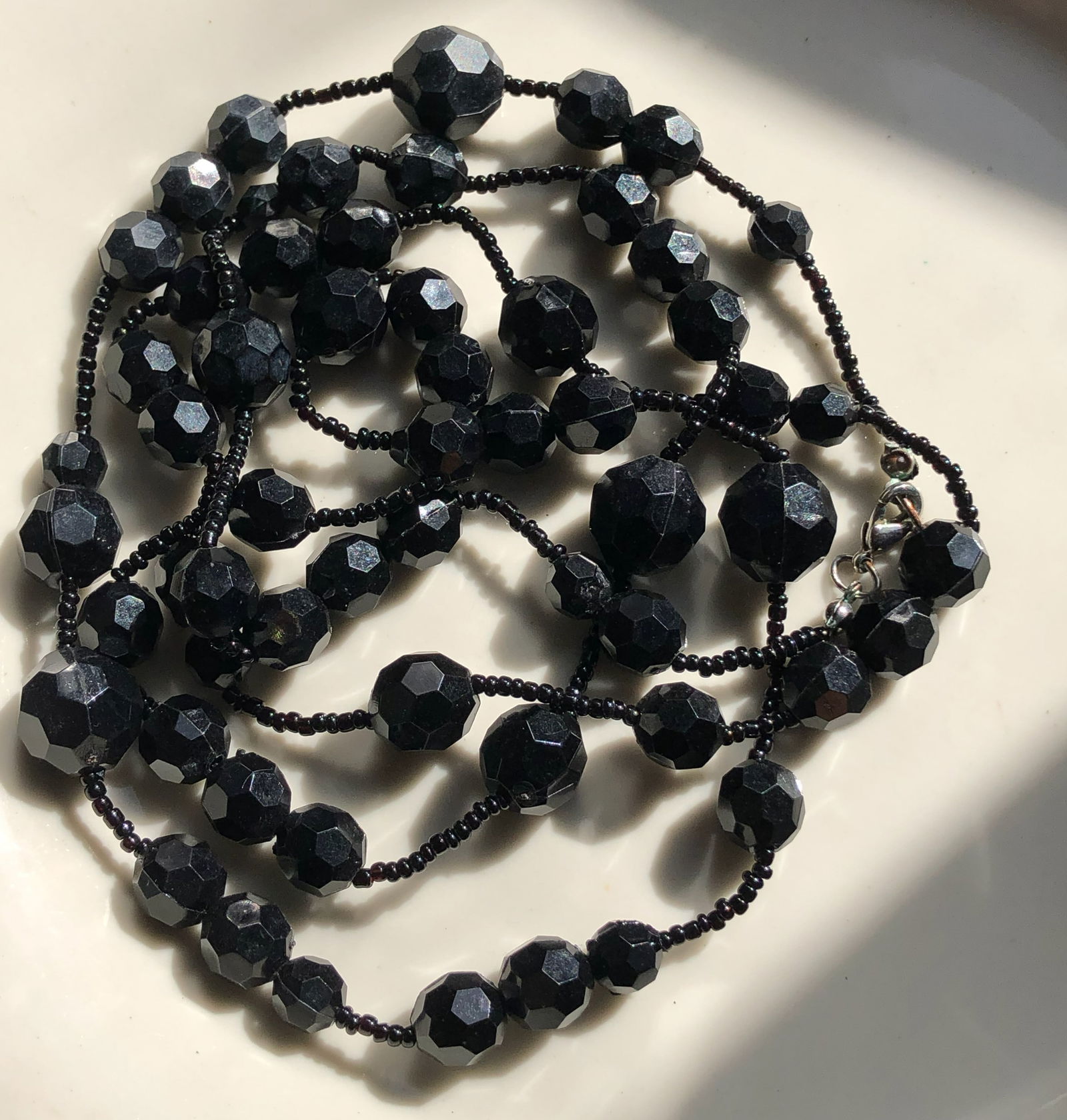 Black Beaded Necklace: Elegant black beaded necklace with faceted beads.