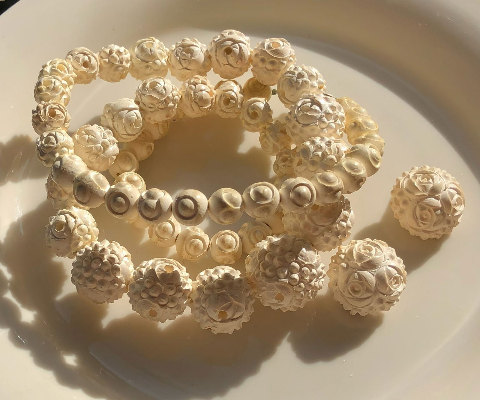 Carved Bead Necklace and Earrings: A beautifully carved bead Necklace and Earrings with intricate floral designs.