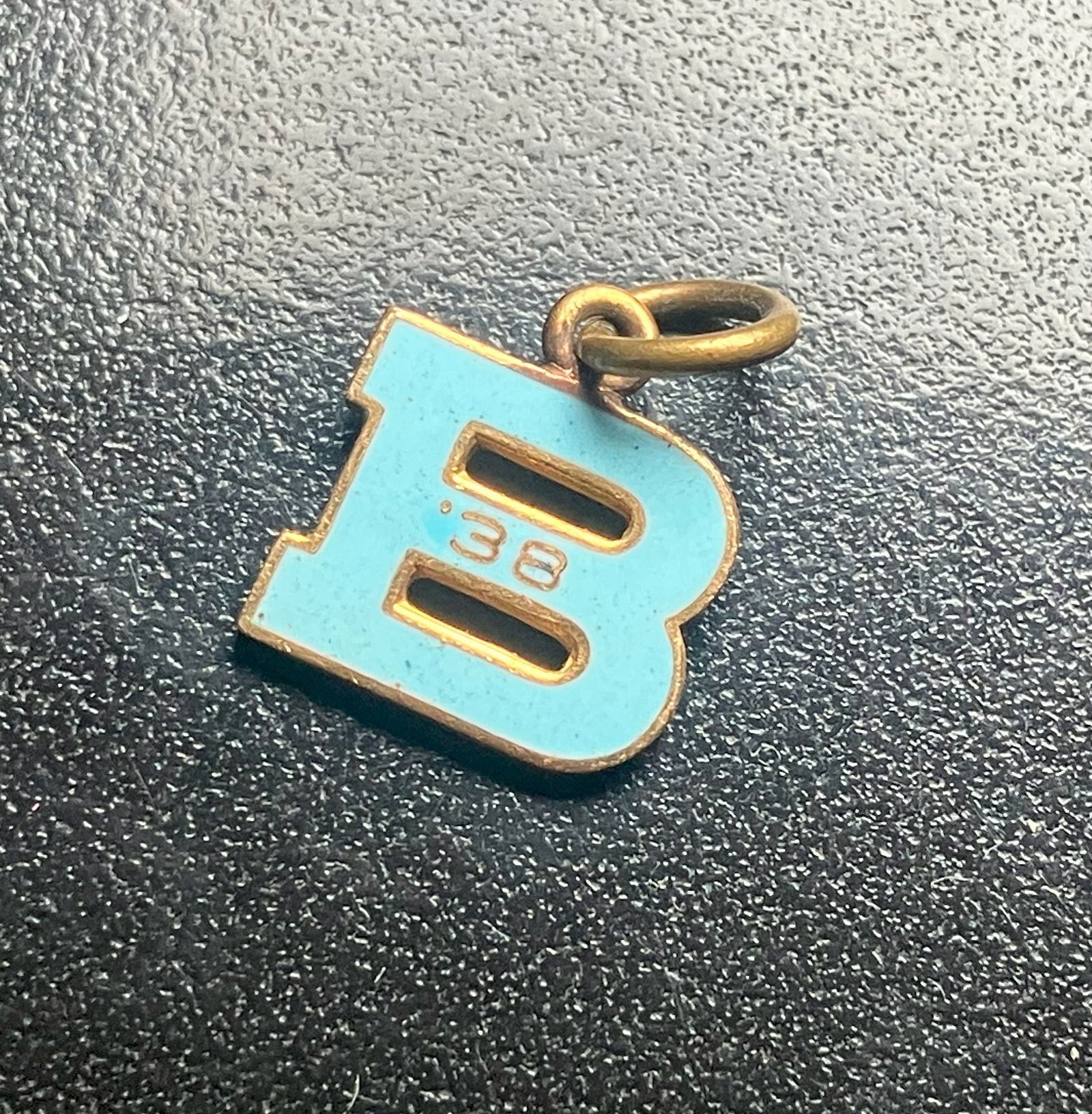 Letter B Charm: A vintage letter B charm with a blue enamel finish.