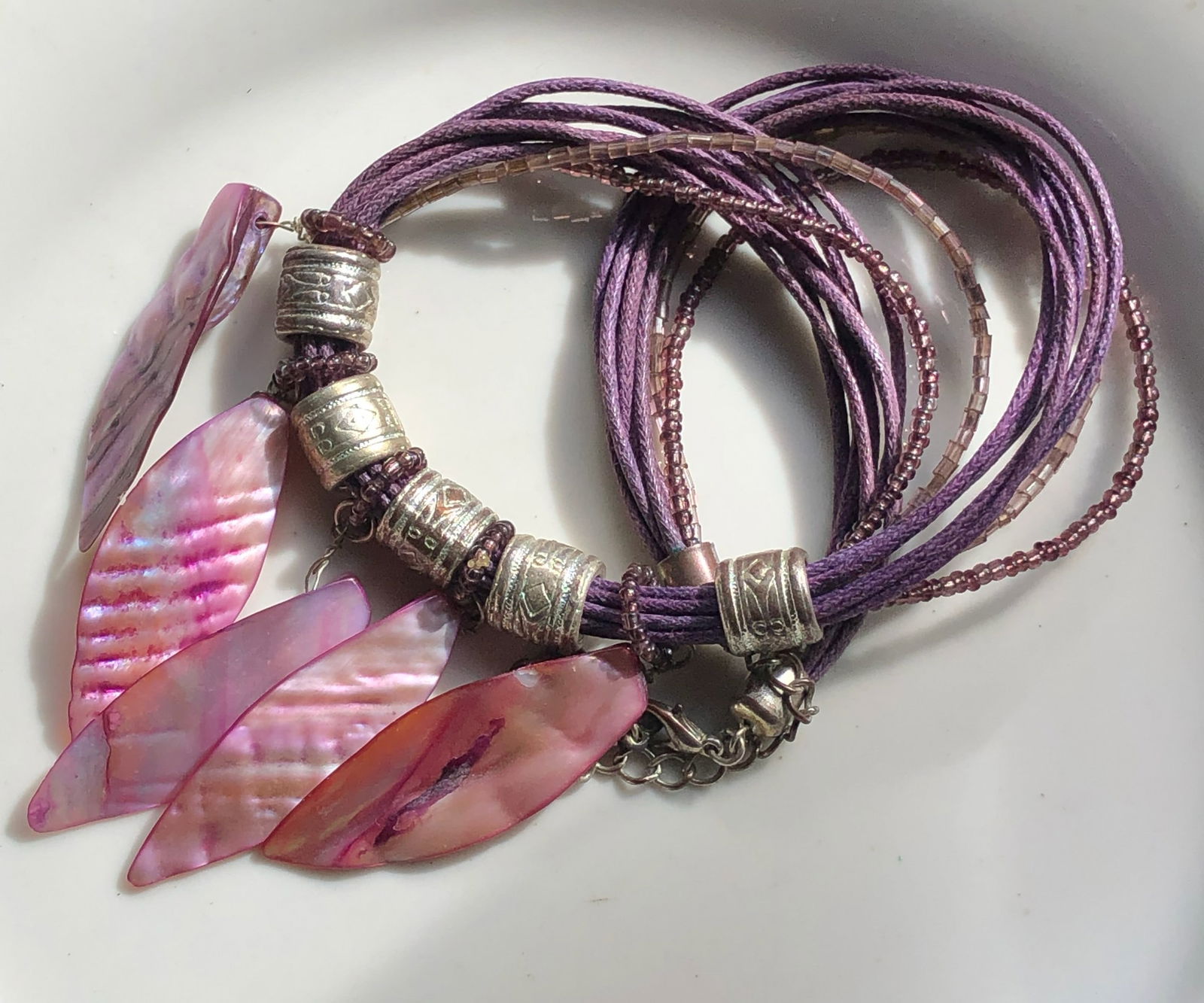 Purple Shell Necklace: A beautiful purple shell necklace with intricate silver accents.