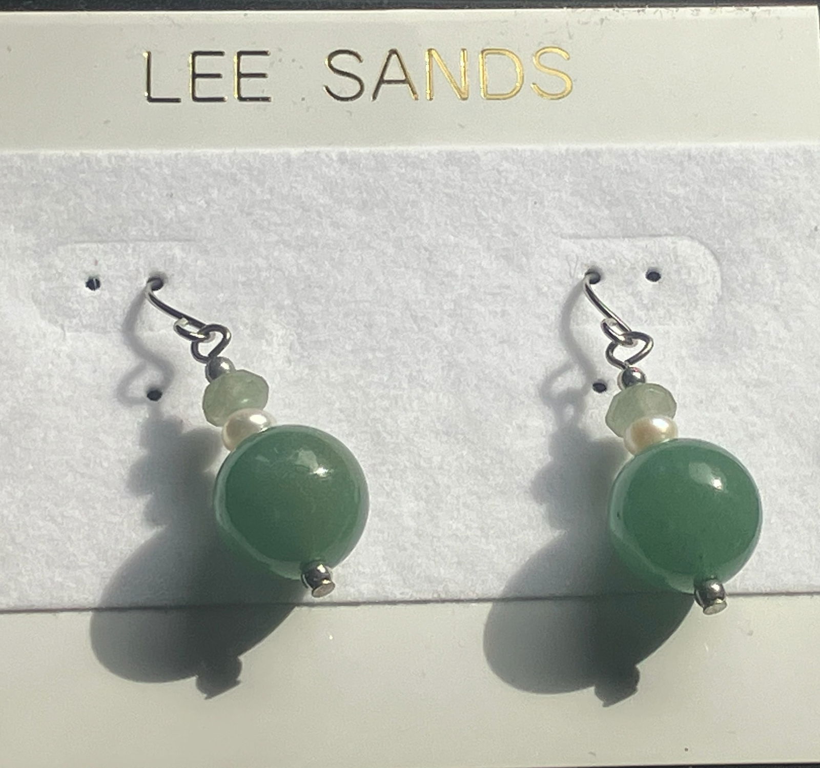 Lee Sands Earrings: Elegant earrings with green beads and pearl accents.
