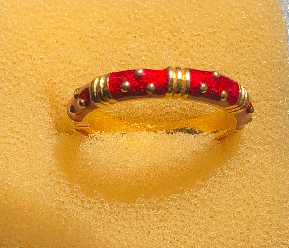 Red Enamel Gold Color Ring: A stunning red enamel ring with gold accents and decorative studs.