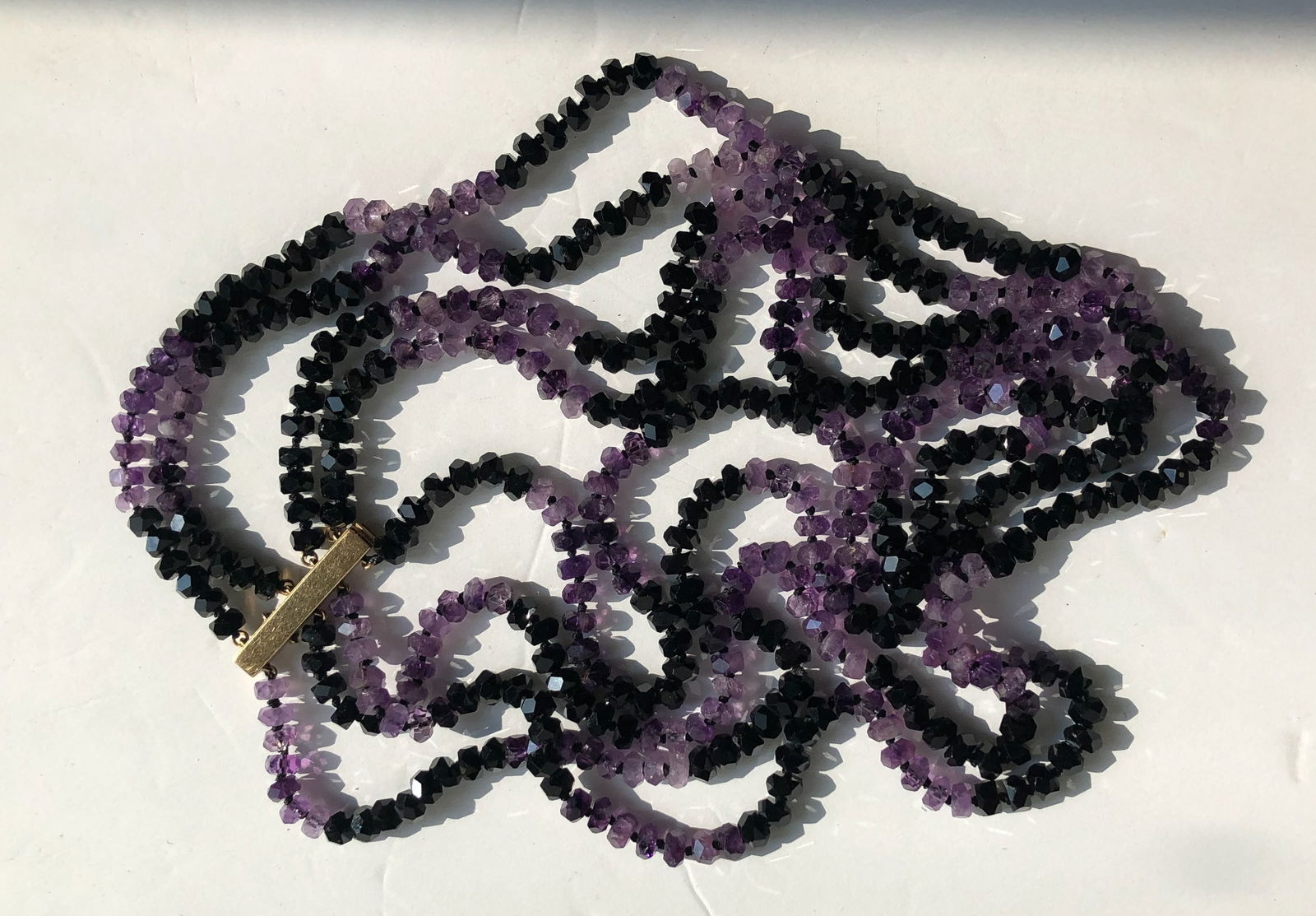 Amethyst and Black Bead Necklace: A beautiful necklace featuring alternating amethyst and black beads.