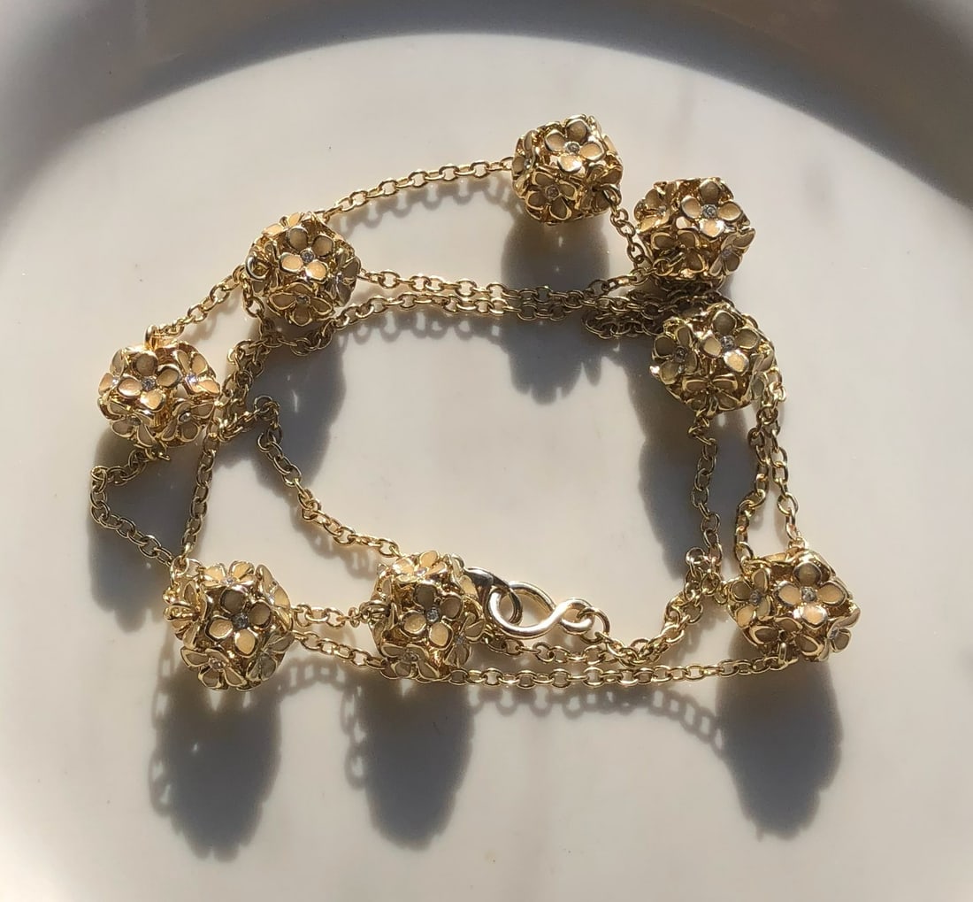 Gold Color Floral Necklace: Elegant gold color necklace with floral design.