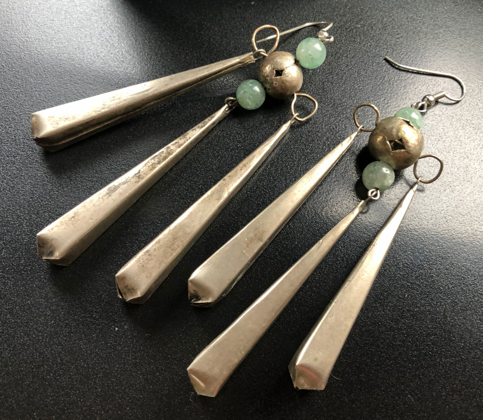 Silver Earrings with Green Beads: Elegant silver earrings featuring green beads and unique design.